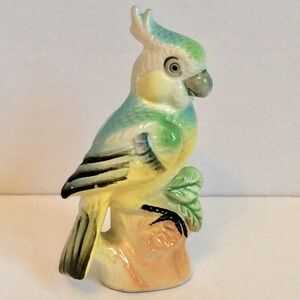 Adorable porcelain parrot figurine.
